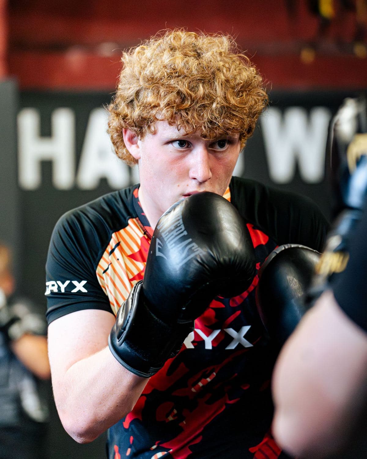 Boxer working pads in a boxing class at Iron Fight Club Worcester